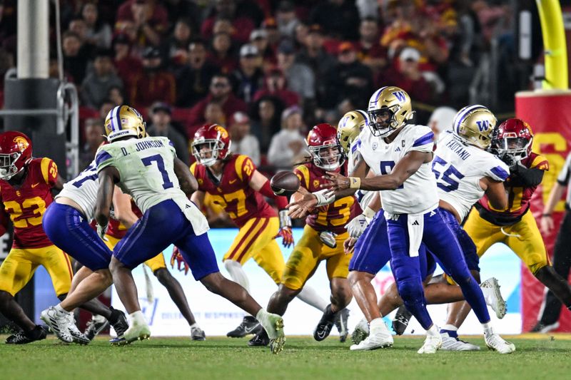 Nov 4, 2023; Los Angeles, California, USA; Washington Huskies quarterback Michael Penix Jr. (9) makes a pass to Washington Huskies running back Dillon Johnson (7) against the USC Trojans during the fourth quarter at United Airlines Field at Los Angeles Memorial Coliseum. Mandatory Credit: Jonathan Hui-USA TODAY Sports