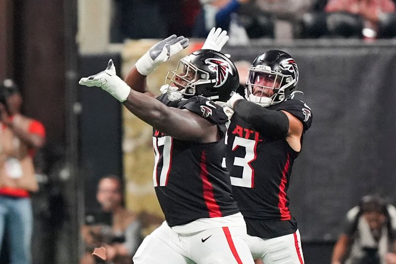 Atlanta Falcons defensive end Grady Jarrett (97) and safety Jessie Bates III (3) celebrate a sack during the first half of an NFL football game against the Dallas Cowboys, Sunday, Nov. 3, 2024, in Atlanta. (AP Photo/ Brynn Anderson)