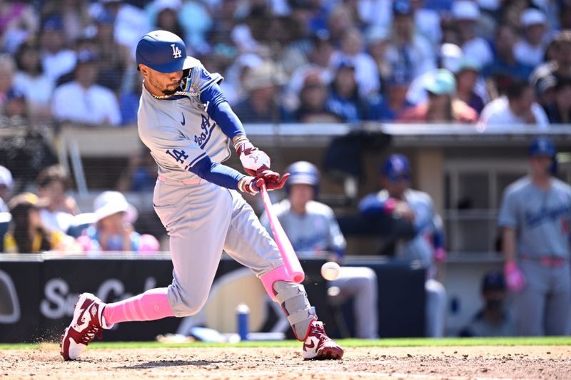 May 12, 2024; San Diego, California, USA; Los Angeles Dodgers shortstop Mookie Betts (50) hits a single against the San Diego Padres during the eighth inning at Petco Park. Mandatory Credit: Orlando Ramirez-USA TODAY Sports