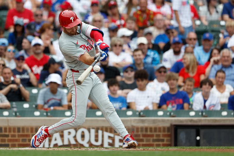 Jul 4, 2024; Chicago, Illinois, USA; Philadelphia Phillies shortstop Trea Turner (7) singles against the Chicago Cubs during the first inning at Wrigley Field. Mandatory Credit: Kamil Krzaczynski-USA TODAY Sports