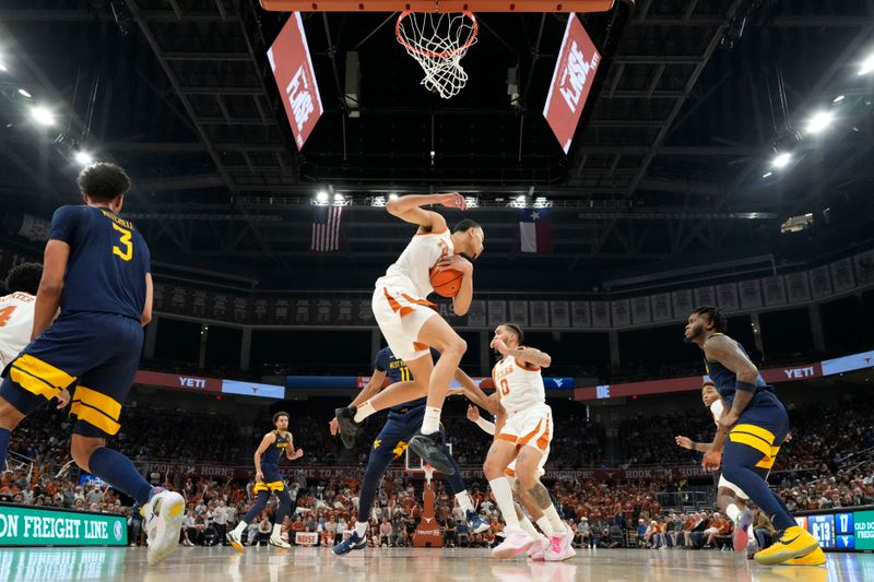 Feb 11, 2023; Austin, Texas, USA; Texas Longhorns forward Dylan Disu (1) comes down with a rebound during the first half against the West Virginia Mountaineers at Moody Center. Mandatory Credit: Scott Wachter-USA TODAY Sports