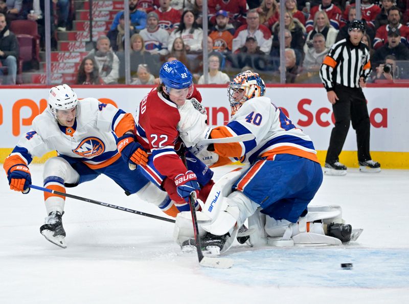 Jan 25, 2024; Montreal, Quebec, CAN; Montreal Canadiens forward Cole Caufield (22) scores a goal against New York Islanders goalie Semyon Varlamov (40) during the first period at the Bell Centre. Mandatory Credit: Eric Bolte-USA TODAY Sports