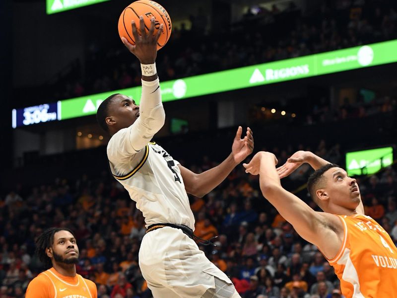 Mar 10, 2023; Nashville, TN, USA; Missouri Tigers guard D'Moi Hodge (5) scores against Tennessee Volunteers guard Tyreke Key (4) during the first half at Bridgestone Arena. Mandatory Credit: Christopher Hanewinckel-USA TODAY Sports