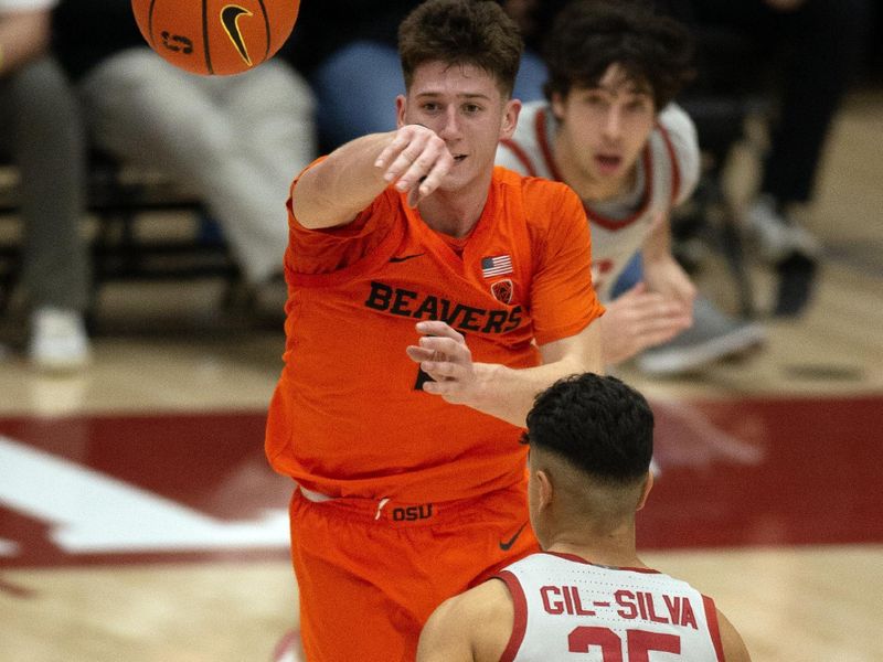 Jan 19, 2023; Stanford, California, USA; Oregon State Beavers guard Nick Krass (2) leaves his feet to pass over Stanford Cardinal guard Josue Gil-Silva (25) during the second half at Maples Pavilion. Stanford defeated Oregon State 67-46. Mandatory Credit: D. Ross Cameron-USA TODAY Sports