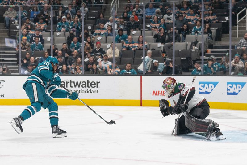 Dec 21, 2023; San Jose, California, USA; San Jose Sharks left wing Anthony Duclair (10) shoots the puck and scores against Arizona Coyotes goaltender Karel Vejmelka (70) during the second period at SAP Center at San Jose. Mandatory Credit: Stan Szeto-USA TODAY Sports