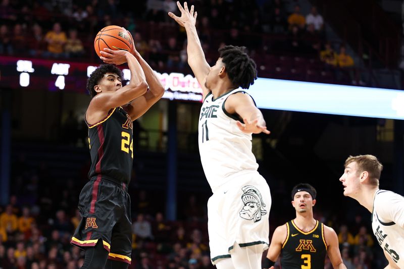 Feb 6, 2024; Minneapolis, Minnesota, USA; Minnesota Golden Gophers guard Cam Christie (24) shoots as Michigan State Spartans guard A.J. Hoggard (11) defends during the first half at Williams Arena. Mandatory Credit: Matt Krohn-USA TODAY Sports