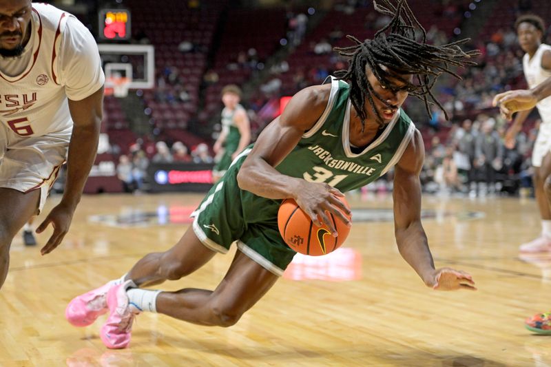 Dec 22, 2025; Tallahassee, Florida, USA; Jacksonville University Dolphins forward Jason Thirdkill Jr. (31) loses control of the ball as Florida State University guard Robert McCray (6) defends during the first half at Donald L. Tucker Center. Mandatory Credit: Melina Myers-Imagn Images