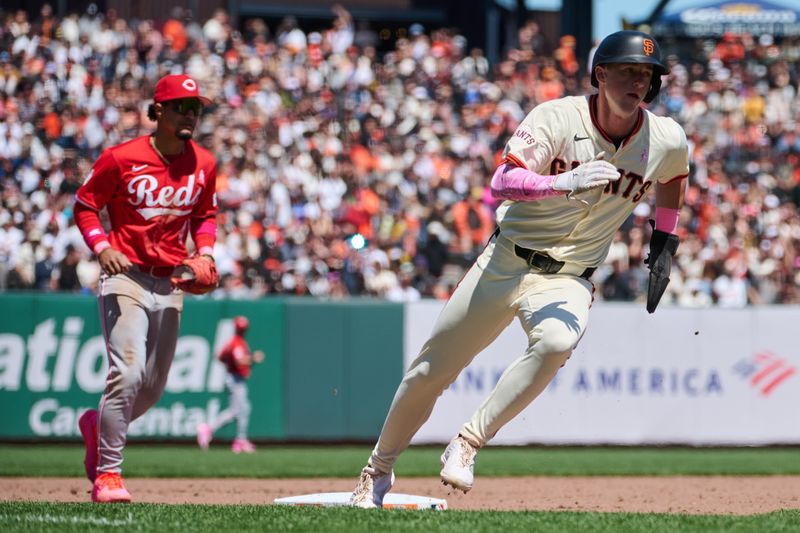 May 12, 2024; San Francisco, California, USA; San Francisco Giants infielder Tyler Fitzgerald (49) rounds third base to score a run against Cincinnati Reds infielder Santiago Espinal (4) during the fifth inning at Oracle Park. Mandatory Credit: Robert Edwards-USA TODAY Sports