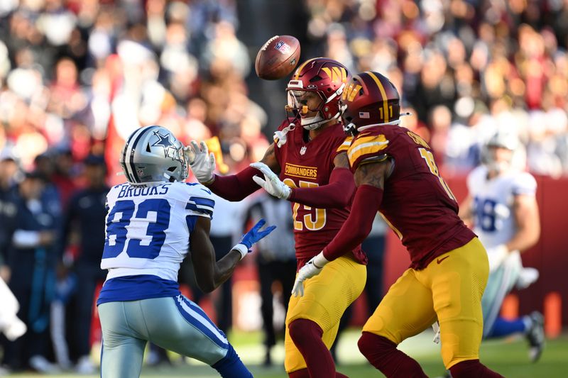 Dallas Cowboys wide receiver Jalen Brooks (83) catches the ball against Washington Commanders cornerback Benjamin St-Juste during the first half of an NFL football game, Sunday, Nov. 24, 2024, in Landover, Md. (AP Photo/Terrance Williams)