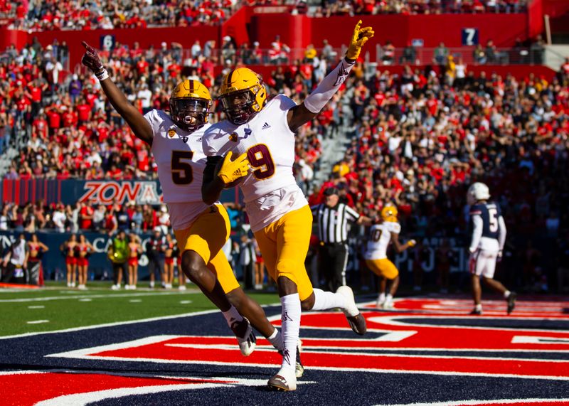 Nov 25, 2022; Tucson, Arizona, USA; Arizona State Sun Devils defensive back Ro Torrence (9) celebrates his interception with teammate Chris Edmonds (5) against the Arizona Wildcats in the first half of the Territorial Cup at Arizona Stadium. Mandatory Credit: Mark J. Rebilas-USA TODAY Sports