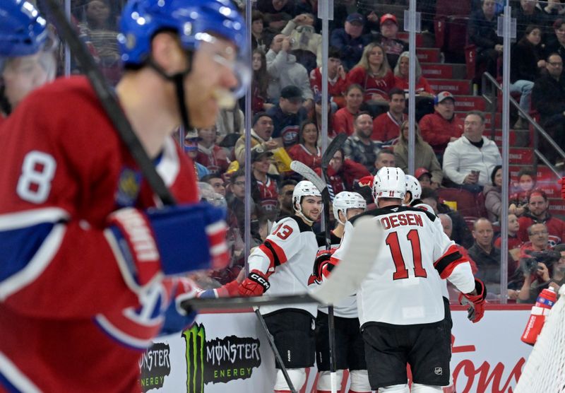 Jan 25, 2025; Montreal, Quebec, CAN; New Jersey Devils forward Nico Hischier (13) celebrates with teammates after scoring a goal against the Montreal Canadiens during the first period at the Bell Centre. Mandatory Credit: Eric Bolte-Imagn Images