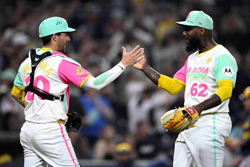 Jun 21, 2024; San Diego, California, USA; San Diego Padres relief pitcher Enyel De Los Santos (62) and catcher Kyle Higashioka (20) celebrate on the field after defeating the Milwaukee Brewers at Petco Park. Mandatory Credit: Orlando Ramirez-USA TODAY Sports