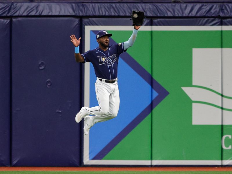 Sep 9, 2023; St. Petersburg, Florida, USA;  Tampa Bay Rays right fielder Vidal Brujan (7) fields the ball against the Seattle Mariners in the eighth inning at Tropicana Field. Mandatory Credit: Nathan Ray Seebeck-USA TODAY Sports