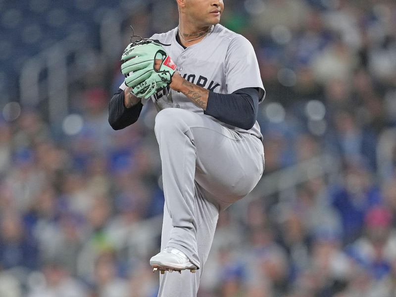 Apr 15, 2024; Toronto, Ontario, CAN; New York Yankees pitcher Luis Gil wearing number 42 for Jackie Robinson Day throws a pitch against the Toronto Blue Jays during the first inning at Rogers Centre. Mandatory Credit: Nick Turchiaro-USA TODAY Sports