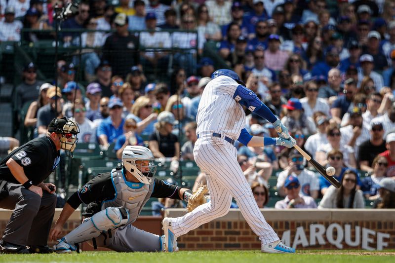 May 5, 2023; Chicago, Illinois, USA; Chicago Cubs left fielder Ian Happ (8) hits a two-run home run against the Miami Marlins during the fifth inning at Wrigley Field. Mandatory Credit: Kamil Krzaczynski-USA TODAY Sports