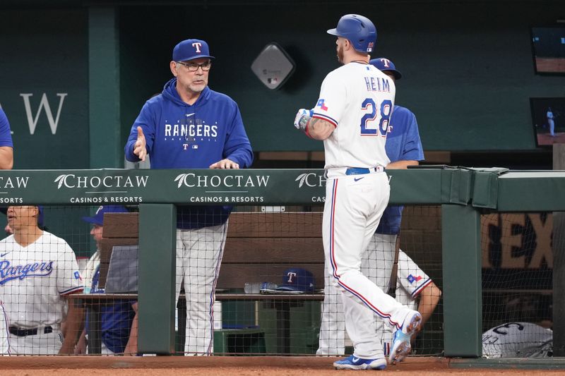 Sep 20, 2023; Arlington, Texas, USA; Texas Rangers catcher Jonah Heim (28) celebrates his three-run home run with manager Bruce Bochy (15) against the Boston Red Sox during the second inning at Globe Life Field. Mandatory Credit: Jim Cowsert-USA TODAY Sports