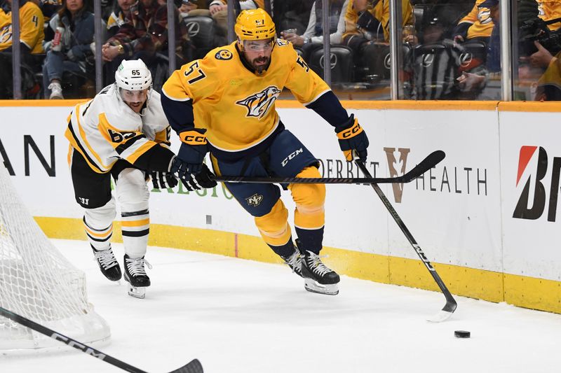 Nov 28, 2023; Nashville, Tennessee, USA; Nashville Predators defenseman Dante Fabbro (57) skates with the puck past Pittsburgh Penguins defenseman Erik Karlsson (65) during the first period at Bridgestone Arena. Mandatory Credit: Christopher Hanewinckel-USA TODAY Sports