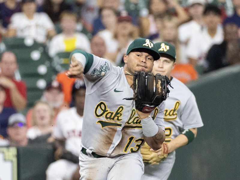 Sep 12, 2023; Houston, Texas, USA; Oakland Athletics third baseman Jordan Diaz (13) doesn   t throw Houston Astros second baseman Jose Altuve (27) (not pictured) out in time at first base in the first inning at Minute Maid Park. Mandatory Credit: Thomas Shea-USA TODAY Sports