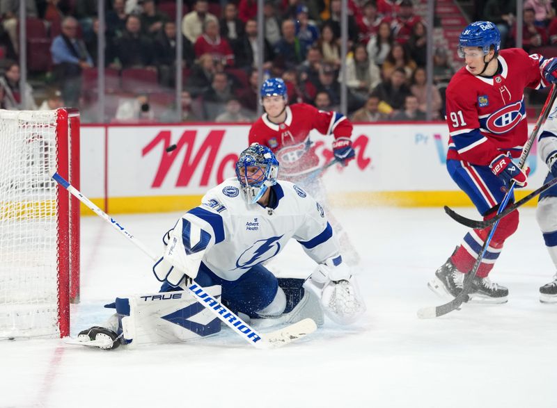 Dec 9, 2025; Montreal, Quebec, CAN; Montreal Canadiens forward Oliver Kapanen (91) scores a goal against Tampa Bay Lightning goalie Jonas Johansson (31) during the second period at the Bell Centre. Mandatory Credit: Eric Bolte-Imagn Images
