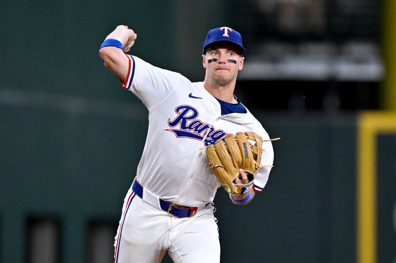 May 1, 2025; Arlington, Texas, USA; Texas Rangers third baseman Josh Jung (6) throws out Athletics catcher Jhonny Pereda (not pictured) during the fifth inning at Globe Life Field. Mandatory Credit: Jerome Miron-Imagn Images