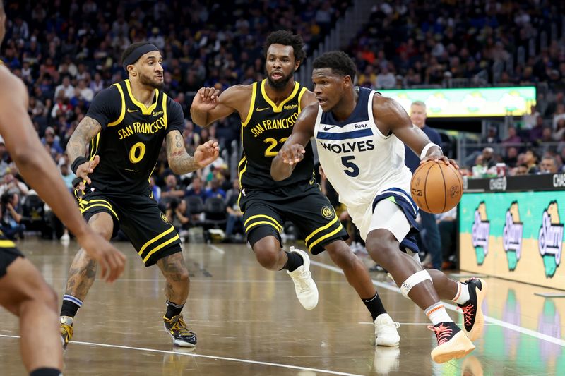 SAN FRANCISCO, CALIFORNIA - NOVEMBER 14: Anthony Edwards #5 of the Minnesota Timberwolves is guarded by Andrew Wiggins #22 and Gary Payton II #0 of the Golden State Warriors at Chase Center on November 14, 2023 in San Francisco, California. NOTE TO USER: User expressly acknowledges and agrees that, by downloading and or using this photograph, User is consenting to the terms and conditions of the Getty Images License Agreement.  (Photo by Ezra Shaw/Getty Images)