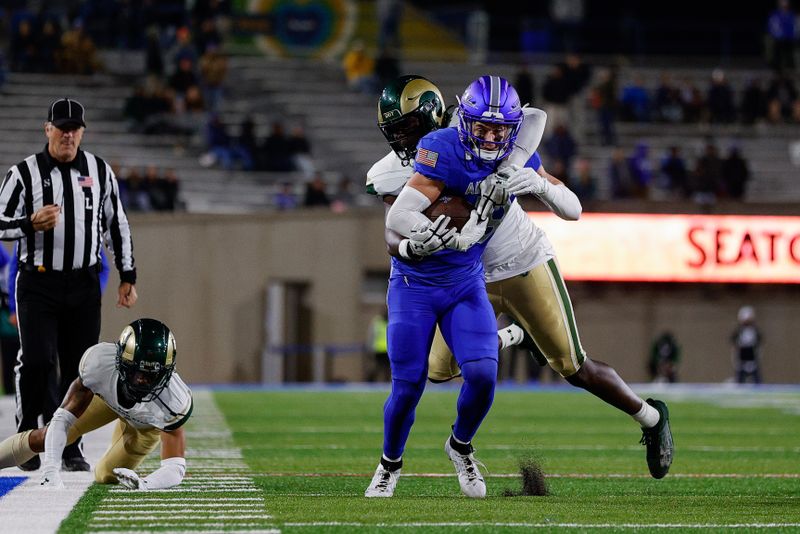 Oct 19, 2024; Colorado Springs, Colorado, USA; Air Force Falcons wide receiver Quin Smith (18) is tackled by Colorado State Rams linebacker Buom Jock (8) in the fourth quarter at Falcon Stadium. Mandatory Credit: Isaiah J. Downing-Imagn Images