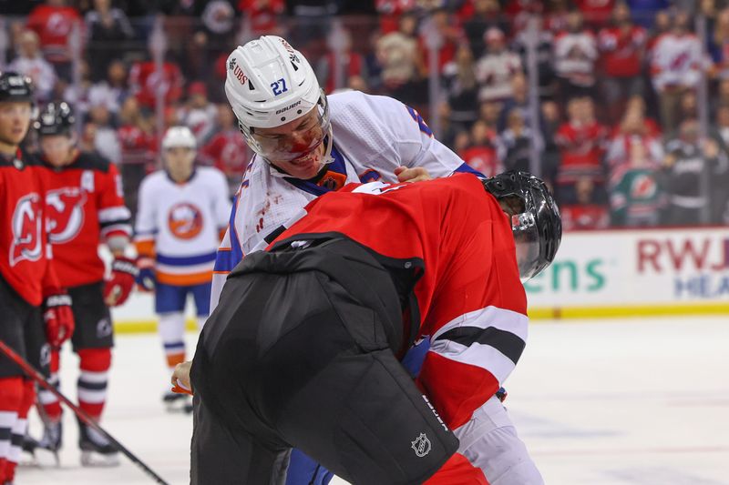 Nov 28, 2023; Newark, New Jersey, USA; New York Islanders left wing Anders Lee (27) and New Jersey Devils defenseman Brendan Smith (2) fight during the third period at Prudential Center. Mandatory Credit: Ed Mulholland-USA TODAY Sports