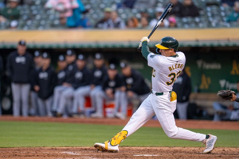 Aug 5, 2024; Oakland, California, USA;  Oakland Athletics center fielder JJ Bleday (33) hits a double against the Chicago White Sox during the fourth inning at Oakland-Alameda County Coliseum. Mandatory Credit: Neville E. Guard-USA TODAY Sports