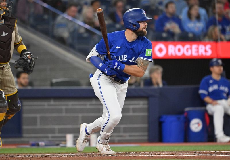 May 21, 2025; Toronto, Ontario, CAN;  Toronto Blue Jays left fielder Nathan Lukes (38) hits a single against the San Diego Padres in the third inning at Rogers Centre. Mandatory Credit: Dan Hamilton-Imagn Images