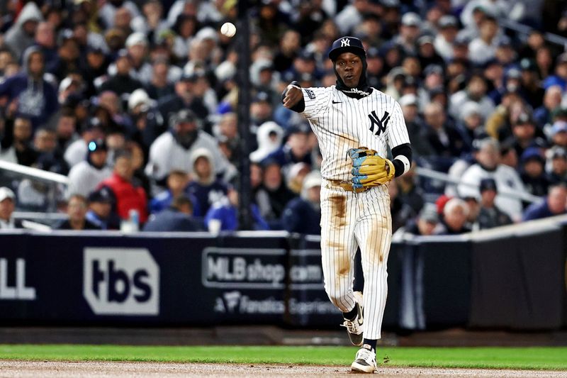 Oct 15, 2024; Bronx, New York, USA; New York Yankees third base Jazz Chisholm Jr. (13) throws to first base for an out during the seventh inning against the Cleveland Guardians in game two of the ALCS for the 2024 MLB Playoffs at Yankee Stadium. Mandatory Credit: Wendell Cruz-Imagn Images