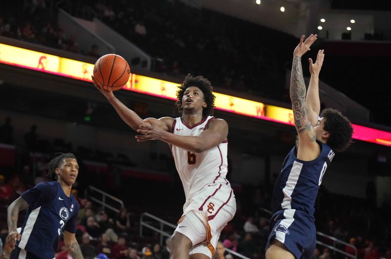 Feb 11, 2025; Los Angeles, California, USA; Southern California Trojans guard Wesley Yates III (6) shoots the ball against Penn State Nittany Lions guard Jahvin Carter (0) in the second half at Galen Center. Mandatory Credit: Kirby Lee-Imagn Images