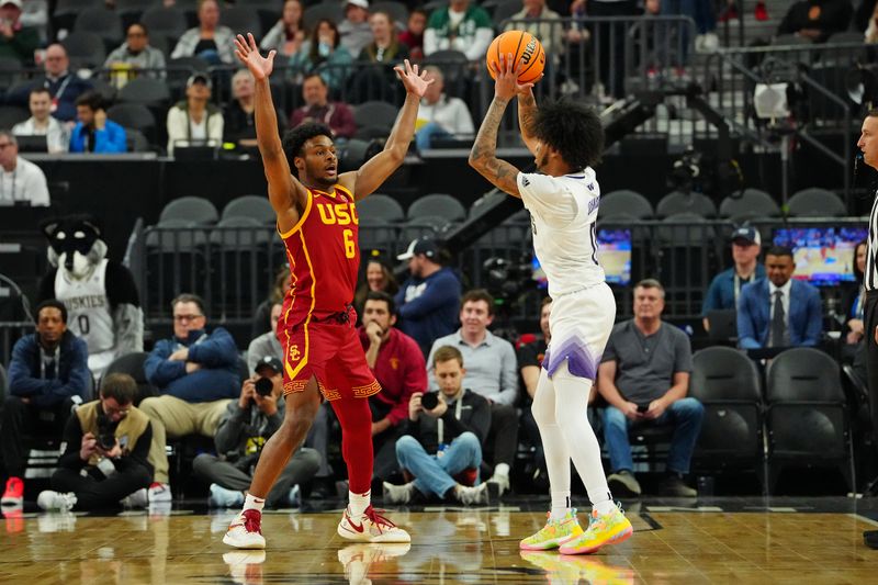 Mar 13, 2024; Las Vegas, NV, USA; USC Trojans guard Bronny James (6) defends against Washington Huskies guard Koren Johnson (0) during the second half at T-Mobile Arena. Mandatory Credit: Stephen R. Sylvanie-USA TODAY Sports