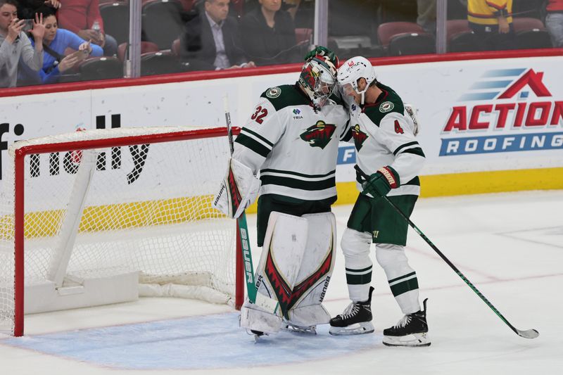 Oct 22, 2024; Sunrise, Florida, USA; Minnesota Wild goaltender Filip Gustavsson (32) celebrates with defenseman Jon Merrill (4) after the game against the Florida Panthers at Amerant Bank Arena. Mandatory Credit: Sam Navarro-Imagn Images