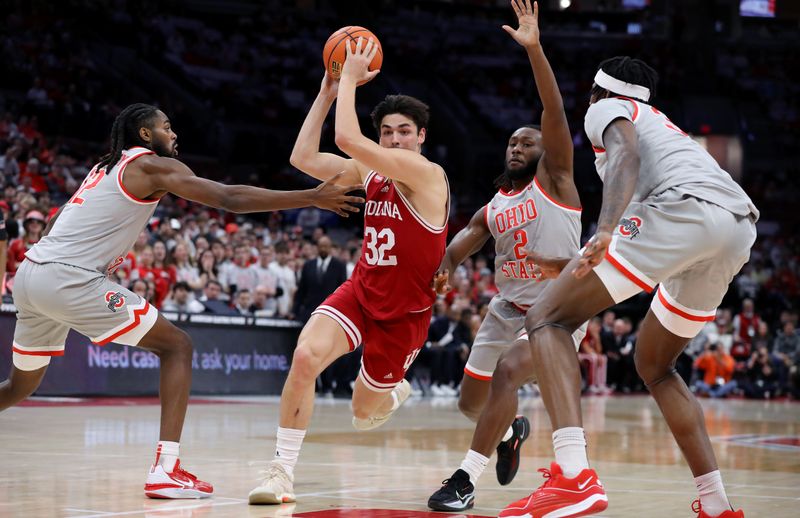 Feb 6, 2024; Columbus, Ohio, USA; Indiana Hoosiers guard Trey Galloway (32) dribbles the ball as Ohio State Buckeyes guard Evan Mahaffey (left) and guard Bruce Thornton (2) defend during the first half at Value City Arena. Mandatory Credit: Joseph Maiorana-USA TODAY Sports