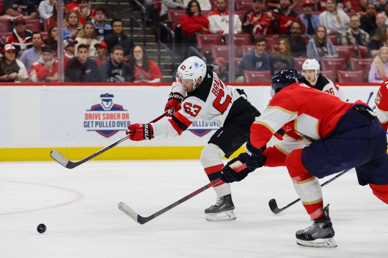 Nov 14, 2024; Sunrise, Florida, USA; New Jersey Devils left wing Jesper Bratt (63) shoots the puck against the Florida Panthers during the first period at Amerant Bank Arena. Mandatory Credit: Sam Navarro-Imagn Images