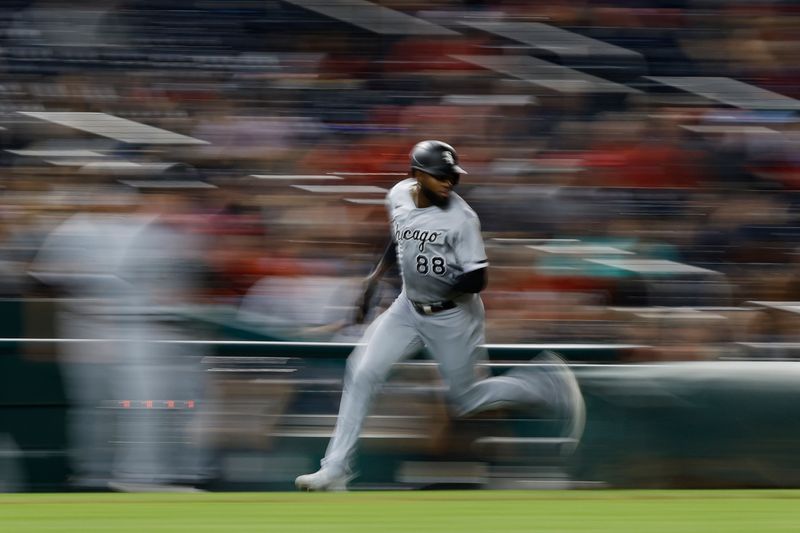 Sep 19, 2023; Washington, District of Columbia, USA; Chicago White Sox center fielder Luis Robert Jr. (88) scores a run on an RBI single by Chicago White Sox designated hitter Eloy Jimenez not pictured) against the Washington Nationals during the ninth inning at Nationals Park. Mandatory Credit: Geoff Burke-USA TODAY Sports