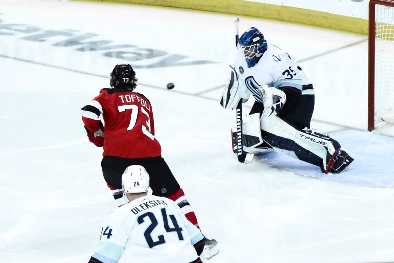 Feb 12, 2024; Newark, New Jersey, USA; Seattle Kraken goaltender Joey Daccord (35) makes a save against the New Jersey Devils during the third period at Prudential Center. Mandatory Credit: John Jones-USA TODAY Sports