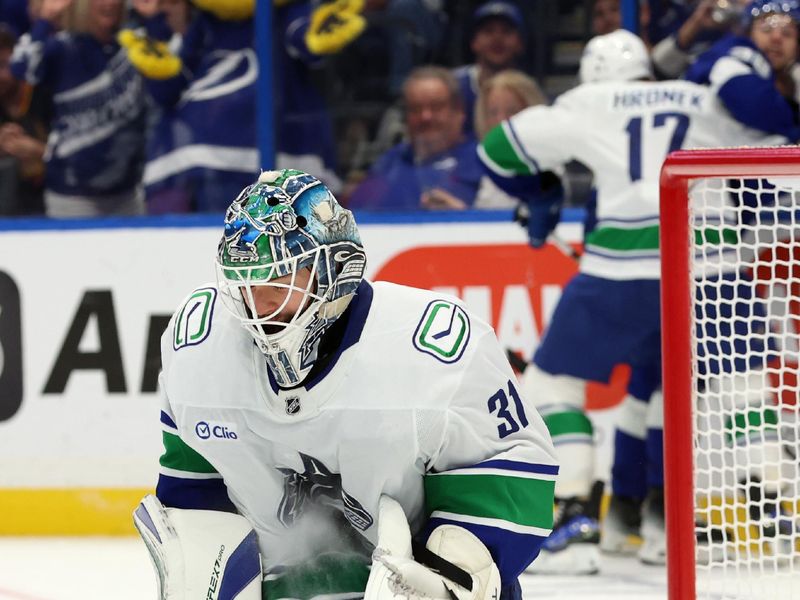 wOct 15, 2024; Tampa, Florida, USA; Vancouver Canucks goaltender Arturs Silovs (31) makes a save against the Tampa Bay Lightning during the third period at Amalie Arena. Mandatory Credit: Kim Klement Neitzel-Imagn Images