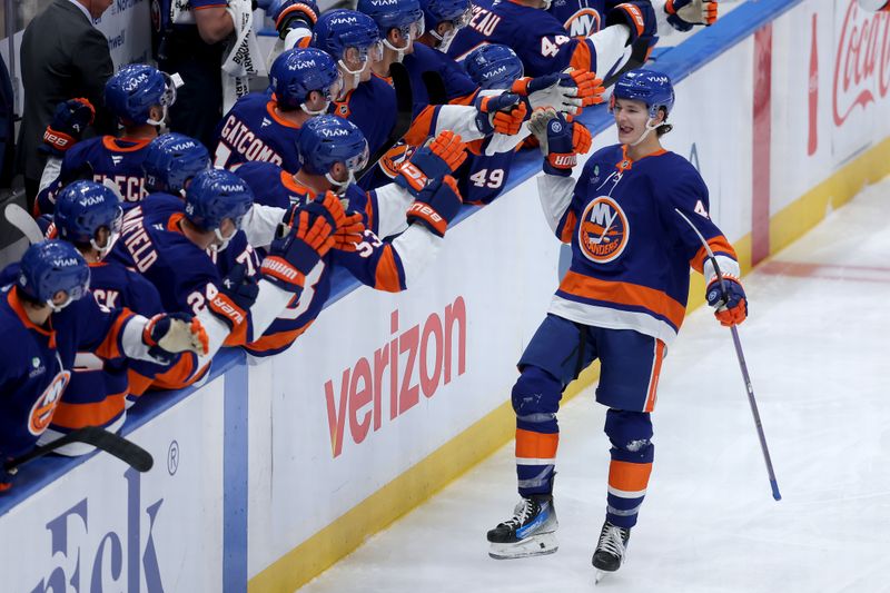 Oct 11, 2025; Elmont, New York, USA; New York Islanders defenseman Matthew Schaefer (48) celebrates his goal against the Washington Capitals with teammates during the third period at UBS Arena. The goal was the first of his NHL career. Mandatory Credit: Brad Penner-Imagn Images