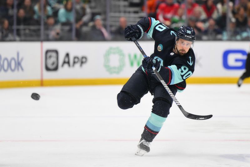 Mar 14, 2024; Seattle, Washington, USA; Seattle Kraken left wing Tomas Tatar (90) passes the puck against the Washington Capitals during the second period at Climate Pledge Arena. Mandatory Credit: Steven Bisig-USA TODAY Sports