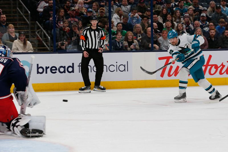 Mar 16, 2024; Columbus, Ohio, USA; San Jose Sharks center Ryan Carpenter (22) shoots  against the Columbus Blue Jackets during the first period at Nationwide Arena. Mandatory Credit: Russell LaBounty-USA TODAY Sports