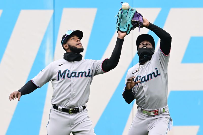 Apr 23, 2023; Cleveland, Ohio, USA; Miami Marlins left fielder Bryan De La Cruz, left, steps in front of center fielder Jazz Chisholm Jr., right, and catches a ball hit by Cleveland Guardians third baseman Jose Ramirez (not pictured) during the fifth inning at Progressive Field. Mandatory Credit: Ken Blaze-USA TODAY Sports