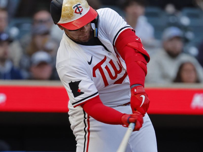 Apr 24, 2024; Minneapolis, Minnesota, USA; Minnesota Twins catcher Christian Vazquez (8) hits an RBI single against the Chicago White Sox in the second inning at Target Field. Mandatory Credit: Bruce Kluckhohn-USA TODAY Sports