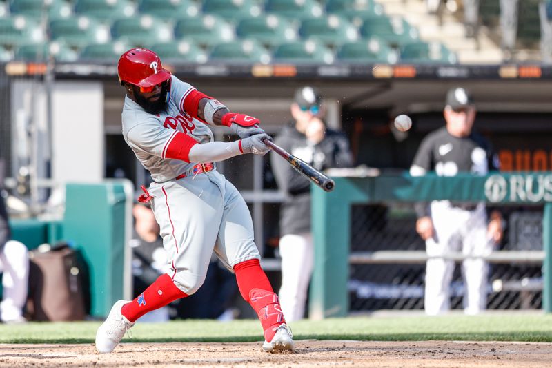 Apr 18, 2023; Chicago, Illinois, USA; Philadelphia Phillies second baseman Josh Harrison (2) hits a two-run single against the Chicago White Sox during the third inning of game one of the doubleheader at Guaranteed Rate Field. Mandatory Credit: Kamil Krzaczynski-USA TODAY Sports