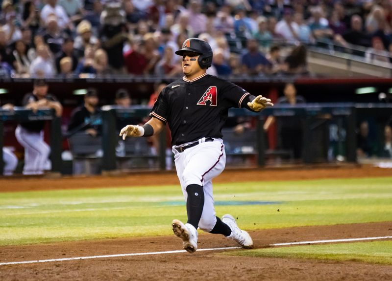 Aug 22, 2023; Phoenix, Arizona, USA; Arizona Diamondbacks catcher Gabriel Moreno scores in the sixth inning against the Texas Rangers at Chase Field. Mandatory Credit: Mark J. Rebilas-USA TODAY Sports