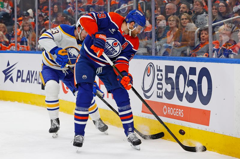 Jan 25, 2025; Edmonton, Alberta, CAN; Edmonton Oilers forward Leon Draisaitl (29) and Buffalo Sabres defensemen Mattias Samuelsson (23) battle along the boards for a loose puck during the first period at Rogers Place. Mandatory Credit: Perry Nelson-Imagn Images