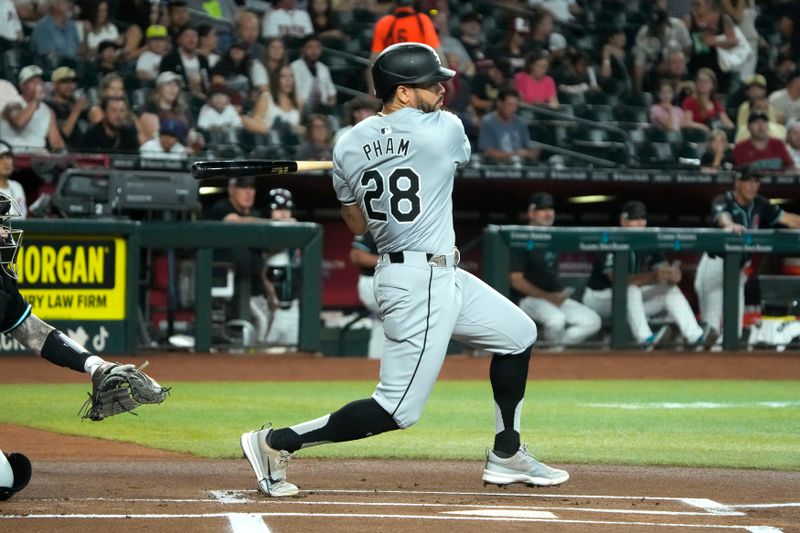 Jun 14, 2024; Phoenix, Arizona, USA; Chicago White Sox second baseman Tommy Pham (28) hits a single against the Arizona Diamondbacks in the first inning at Chase Field. Mandatory Credit: Rick Scuteri-USA TODAY Sports