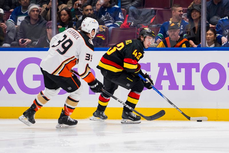 Nov 28, 2023; Vancouver, British Columbia, CAN; Vancouver Canucks defenseman Quinn Hughes (43) drives past Anaheim Ducks forward Sam Carrick (39) in the second period at Rogers Arena. Mandatory Credit: Bob Frid-USA TODAY Sports