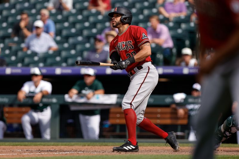 Aug 16, 2023; Denver, Colorado, USA; Arizona Diamondbacks right fielder Tommy Pham (28) watches his ball on a sacrifice fly RBI in the ninth inning against the Colorado Rockies at Coors Field. Mandatory Credit: Isaiah J. Downing-USA TODAY Sports