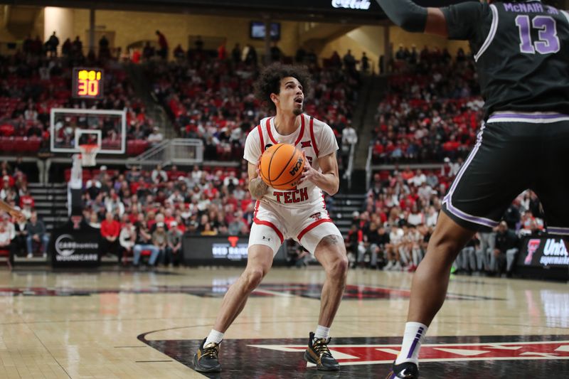 Jan 13, 2024; Lubbock, Texas, USA;  Texas Tech Red Raiders guard Pop Isaacs (2) stops to shoot in front of Kansas State Wildcats center Will McNair Jr. (13) in the first half at United Supermarkets Arena. Mandatory Credit: Michael C. Johnson-USA TODAY Sports